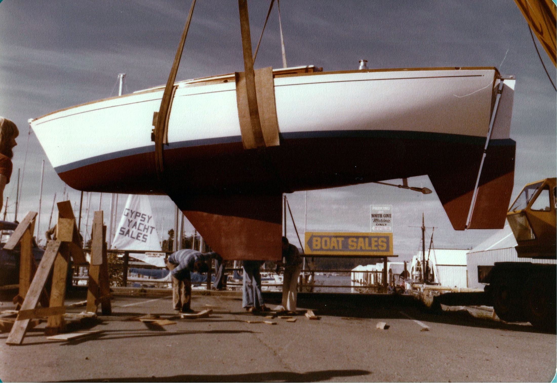 The finished hull in crane slings at the yard