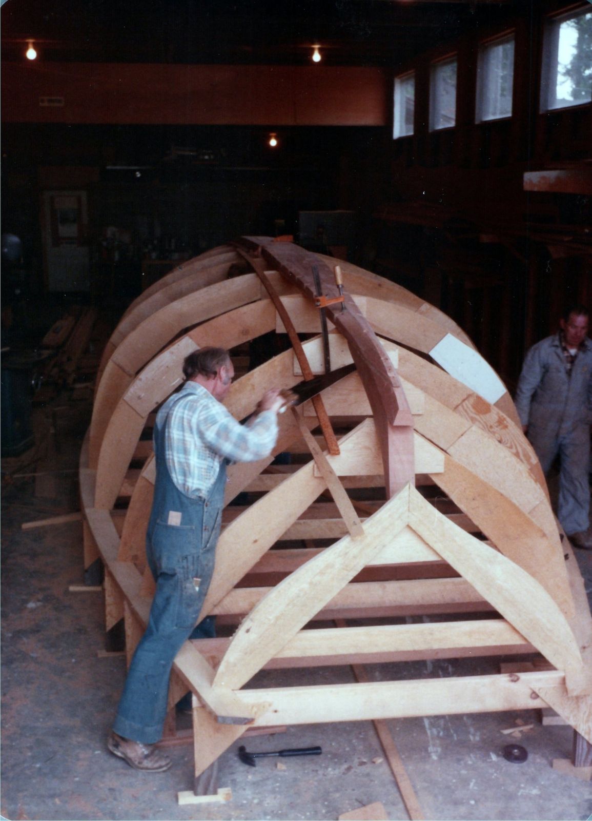 A man fitting a mold at the forward end of the jig