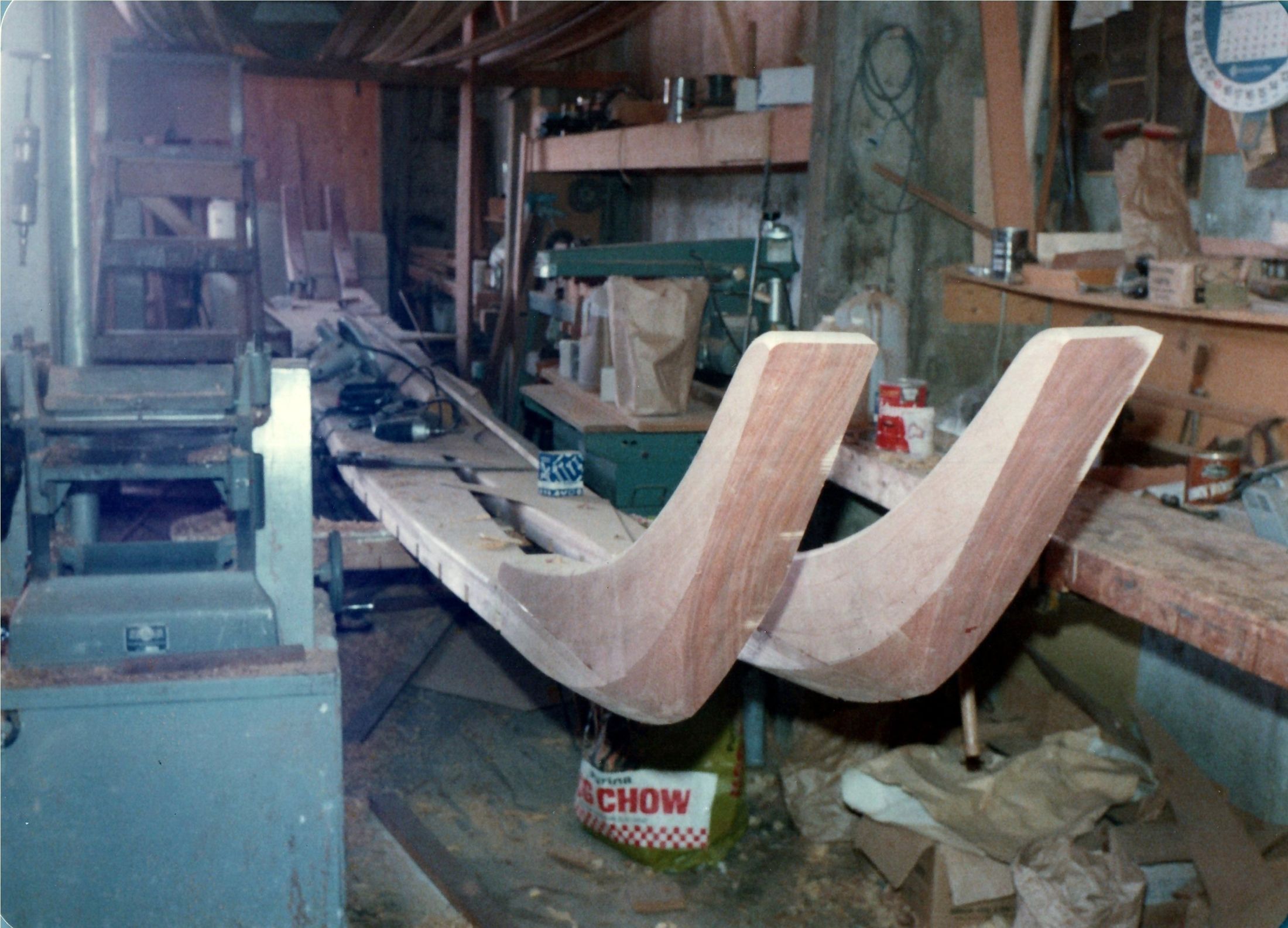 Laminated curved timbers on the bench, the bandsaw behind