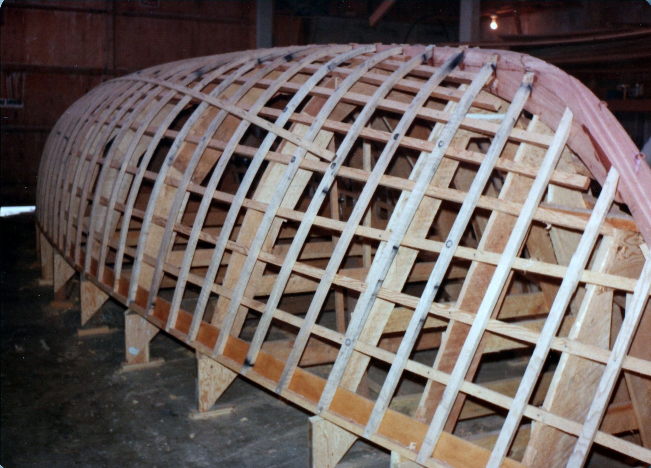 The framed hull upside down, stringers running the length of the molds
