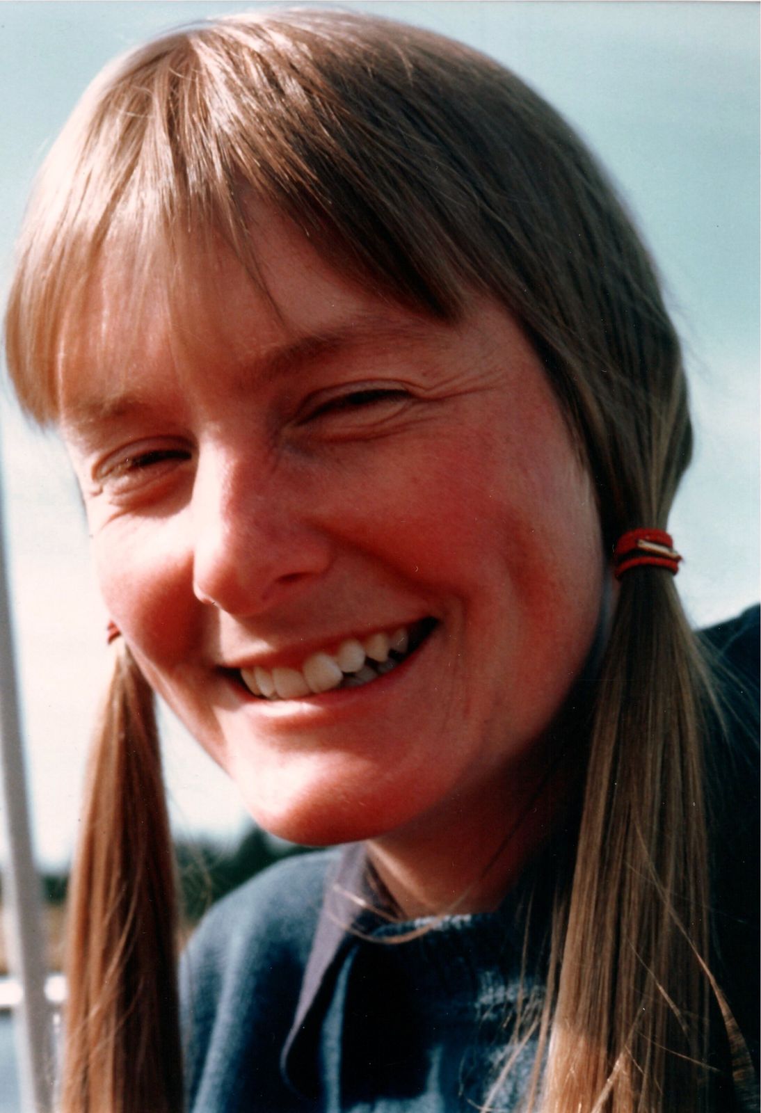 A woman smiling on the dock