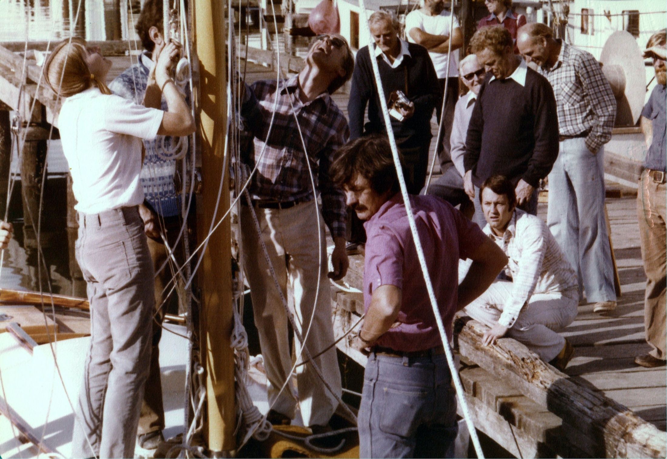 Stepping the mast, a crowd of hands at the foot